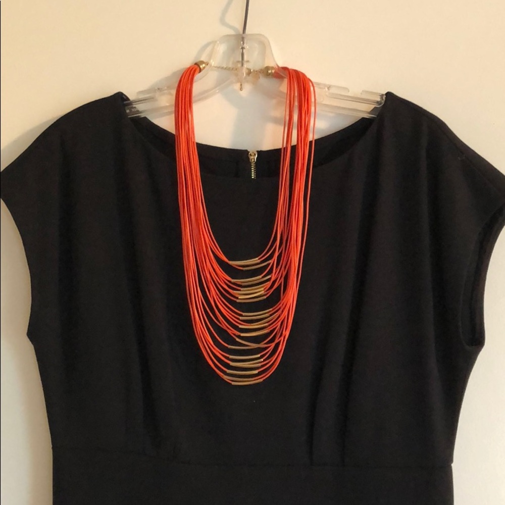 Orange leather and gold necklace. Adjustable.